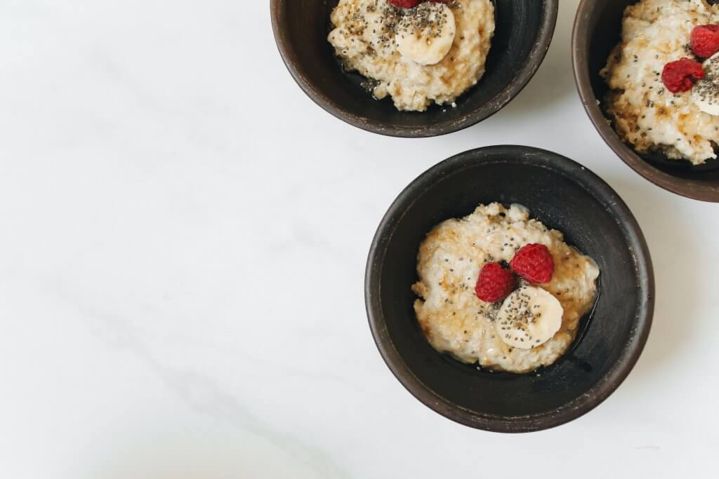 A jar of overnight oats topped with fresh berries.