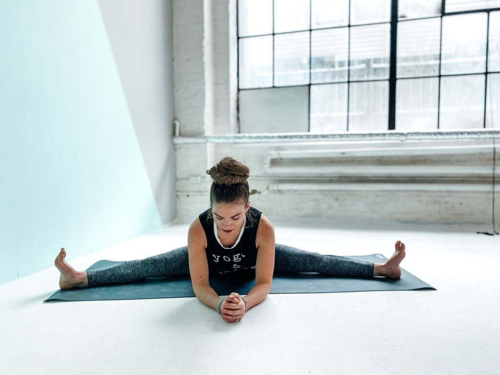 Woman in a calming Wide-Legged Seated Forward Fold.